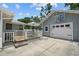 Backyard featuring a garage with a basketball hoop and a covered patio with outdoor seating area at 2811 W Sitios St, Tampa, FL 33629