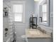 Bright bathroom features marble countertop, updated fixtures and tiled shower with patterned shower curtain at 2811 W Sitios St, Tampa, FL 33629