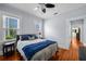 Bright bedroom with hardwood floors, two windows, and neutral paint at 2811 W Sitios St, Tampa, FL 33629