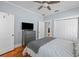 Well-lit bedroom with a dresser, closet, and hardwood floors at 2811 W Sitios St, Tampa, FL 33629