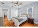 Comfortable bedroom with a ceiling fan, hardwood floors, and neutral walls at 2811 W Sitios St, Tampa, FL 33629