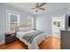 Inviting bedroom featuring hardwood floors, neutral walls, and windows that let in natural light at 2811 W Sitios St, Tampa, FL 33629