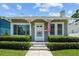 Quaint home featuring an American flag, manicured landscaping, and a welcoming front entrance at 2811 W Sitios St, Tampa, FL 33629