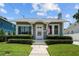 Charming single-story home featuring manicured landscaping, light gray paint, trimmed bushes and a classic design at 2811 W Sitios St, Tampa, FL 33629