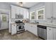 Efficient kitchen features stainless appliances, white cabinets, and tiled backsplash at 2811 W Sitios St, Tampa, FL 33629