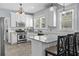 Well-lit kitchen boasts white cabinets, stainless steel appliances, and granite countertops at 2811 W Sitios St, Tampa, FL 33629