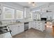 Open kitchen with granite counters and an adjacent living space at 2811 W Sitios St, Tampa, FL 33629
