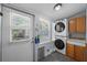 Functional laundry room with stacked washer/dryer and practical storage solutions at 2811 W Sitios St, Tampa, FL 33629