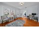 Cozy living room with hardwood floors, two chairs and a view to the office in the adjacent room at 2811 W Sitios St, Tampa, FL 33629