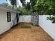 Fenced backyard featuring wood mulch, putting green, storage shed, and a batting net at 2820 Whitney Rd, Clearwater, FL 33760