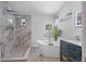 Luxurious bathroom featuring a soaking tub, walk-in shower, and modern vanity at 2820 Whitney Rd, Clearwater, FL 33760