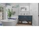 Elegant bathroom featuring a soaking tub, stylish vanity, and contemporary fixtures at 2820 Whitney Rd, Clearwater, FL 33760