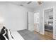 Bedroom with a closet featuring mirrored doors and a view of living room at 2820 Whitney Rd, Clearwater, FL 33760