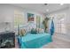 Bright bedroom with natural light and wood-look floors and blue furnishings at 2820 Whitney Rd, Clearwater, FL 33760