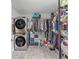 Walk-in closet features shelving, hanging racks, storage, and stacked washer/dryer at 2820 Whitney Rd, Clearwater, FL 33760
