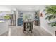 Bright dining room featuring views through sliding glass doors and modern decor at 2820 Whitney Rd, Clearwater, FL 33760