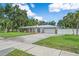 Beautiful single-story home boasts well-manicured lawn, mature trees, and a paved driveway with a two-car garage at 2820 Whitney Rd, Clearwater, FL 33760