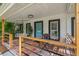 Inviting front porch with tile flooring, swing, and seating area offers a relaxing outdoor space at 2820 Whitney Rd, Clearwater, FL 33760