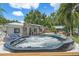 Relaxing hot tub area with lush landscaping and a view of the backyard at 2820 Whitney Rd, Clearwater, FL 33760