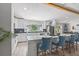 This kitchen features an island with barstool seating, white cabinets and stainless appliances at 2820 Whitney Rd, Clearwater, FL 33760
