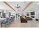 Open-concept living room featuring high ceilings, wood beams, a fireplace, and bar seating at 2820 Whitney Rd, Clearwater, FL 33760