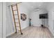 Cozy loft space featuring modern decor, wood laminate flooring, and a convenient ladder at 2820 Whitney Rd, Clearwater, FL 33760