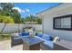 Outdoor seating area with plush cushions, a fire pit table, and well-manicured landscaping at 2820 Whitney Rd, Clearwater, FL 33760