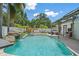 Backyard pool with a waterfall feature and a lounge area for relaxing and entertaining at 2820 Whitney Rd, Clearwater, FL 33760