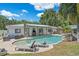 Backyard with pool, lounge chairs, and outdoor seating, perfect for relaxation and entertainment at 2820 Whitney Rd, Clearwater, FL 33760