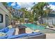 Backyard pool featuring a lounge area with a fire pit and a waterfall at 2820 Whitney Rd, Clearwater, FL 33760