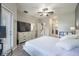 Spacious bedroom featuring neutral tones, a ceiling fan, a large dresser, and access to a private balcony at 28504 Tranquil Lake Cir, Wesley Chapel, FL 33543