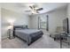 Cozy bedroom featuring a grey color palette, decorative chair, side table, and windows for natural light at 28504 Tranquil Lake Cir, Wesley Chapel, FL 33543