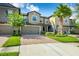 Charming townhome with well-maintained landscaping, brick paved driveway, and attached two-car garage at 28504 Tranquil Lake Cir, Wesley Chapel, FL 33543