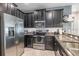 Modern kitchen featuring stainless steel appliances, granite countertops, and dark wood cabinetry at 28504 Tranquil Lake Cir, Wesley Chapel, FL 33543