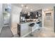 Open-concept kitchen with tile flooring, granite breakfast bar, stainless steel appliances and dark wood cabinetry at 28504 Tranquil Lake Cir, Wesley Chapel, FL 33543