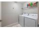 Laundry room featuring a white washer and dryer and a shelf for storage at 28504 Tranquil Lake Cir, Wesley Chapel, FL 33543