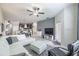 Bright living room with tile flooring, neutral decor, ceiling fan, and a view to the kitchen at 28504 Tranquil Lake Cir, Wesley Chapel, FL 33543