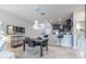 Open-concept living room with tile flooring, modern furniture, and a view to the kitchen at 28504 Tranquil Lake Cir, Wesley Chapel, FL 33543