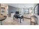 Open-concept living room with tile flooring, modern furniture, and a view to the fenced-in backyard at 28504 Tranquil Lake Cir, Wesley Chapel, FL 33543
