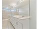 Bright bathroom featuring double sink vanity, shower, and tile flooring at 2885 Deer Pine Trl, Land O Lakes, FL 34638