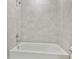 Tiled bathtub offers a relaxing space with chrome fixtures and neutral-toned tile at 2885 Deer Pine Trl, Land O Lakes, FL 34638