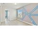 Modern bedroom with geometric accent wall, wood floors, and plenty of natural light at 2885 Deer Pine Trl, Land O Lakes, FL 34638