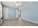 Bright bedroom with light blue walls, white trim, ceiling fan, and wood-look flooring at 2885 Deer Pine Trl, Land O Lakes, FL 34638