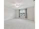 Spacious carpeted bedroom with ceiling fan and large window at 2885 Deer Pine Trl, Land O Lakes, FL 34638