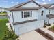 Charming two-story townhome showcasing light blue siding, a well-manicured lawn, and a two-car garage at 2885 Deer Pine Trl, Land O Lakes, FL 34638