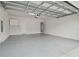 Spacious two-car garage with white walls and an epoxy floor at 2885 Deer Pine Trl, Land O Lakes, FL 34638