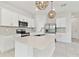 Bright kitchen with an island, stainless steel appliances, and white cabinetry for a clean look at 2885 Deer Pine Trl, Land O Lakes, FL 34638