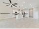 Open kitchen with white cabinets, stainless steel appliances, pendant lighting, and tile flooring at 2885 Deer Pine Trl, Land O Lakes, FL 34638