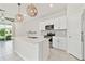 Well-lit kitchen showcasing the kitchen island, stainless steel appliances, and open layout at 2885 Deer Pine Trl, Land O Lakes, FL 34638