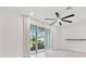 Bright living room with large sliding glass doors, tile floors, and a contemporary ceiling fan at 2885 Deer Pine Trl, Land O Lakes, FL 34638